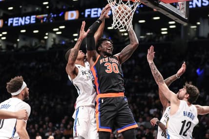 Jan 28, 2023; Brooklyn, New York, USA;  New York Knicks forward Julius Randle (30) drives past Brooklyn Nets center Nic Claxton (33) for a layup attempt in the second quarter at Barclays Center. Mandatory Credit: Wendell Cruz-USA TODAY Sports