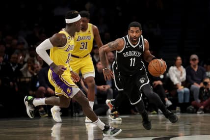 Jan 30, 2023; Brooklyn, New York, USA; Brooklyn Nets guard Kyrie Irving (11) brings the ball up court against Los Angeles Lakers guard Dennis Schroder (17) during the first quarter at Barclays Center. Mandatory Credit: Brad Penner-USA TODAY Sports