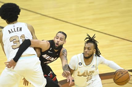Jan 31, 2023; Cleveland, Ohio, USA; Miami Heat forward Caleb Martin (16) tries to get between Cleveland Cavaliers center Jarrett Allen (31) and guard Darius Garland (10) in the fourth quarter at Rocket Mortgage FieldHouse. Mandatory Credit: David Richard-USA TODAY Sports
