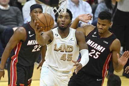 Jan 31, 2023; Cleveland, Ohio, USA; Cleveland Cavaliers guard Donovan Mitchell (45) drives to the basket past Miami Heat forward Jimmy Butler (22) and center Orlando Robinson (25) in the third quarter at Rocket Mortgage FieldHouse. Mandatory Credit: David Richard-USA TODAY Sports