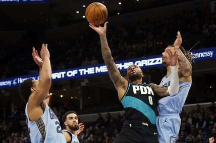 Feb 1, 2023; Memphis, Tennessee, USA; Portland Trail Blazers guard Damian Lillard (0) moves to the basket as Memphis Grizzlies guard Desmond Bane (22) and Memphis Grizzlies forward Brandon Clark (15) defend during the first half at FedExForum. Mandatory Credit: Petre Thomas-USA TODAY Sports