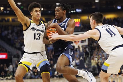Feb 1, 2023; Milwaukee, Wisconsin, USA;  Villanova Wildcats forward Brandon Slater (34) drives for the basket between Marquette Golden Eagles forward Oso Ighodaro (13) and guard Tyler Kolek (11) during the first half at Fiserv Forum. Mandatory Credit: Jeff Hanisch-USA TODAY Sports