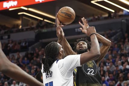 Feb 1, 2023; Minneapolis, Minnesota, USA; Golden State Warriors forward Andrew Wiggins (22) shoots against the Minnesota Gophers Minnesota Timberwolves center Naz Reid (11) in the first quarter at Target Center. Mandatory Credit: Bruce Kluckhohn-USA TODAY Sports
