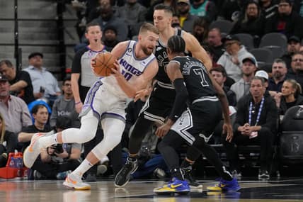 Feb 1, 2023; San Antonio, Texas, USA;  Sacramento Kings forward Domantas Sabonis (10) drives around San Antonio Spurs forward Zach Collins (23) in the first half at the AT&T Center. Mandatory Credit: Daniel Dunn-USA TODAY Sports