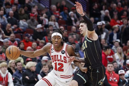 Feb 2, 2023; Chicago, Illinois, USA; Chicago Bulls guard Ayo Dosunmu (12) drives to the basket against Charlotte Hornets guard LaMelo Ball (1) during the first half at United Center. Mandatory Credit: Kamil Krzaczynski-USA TODAY Sports
