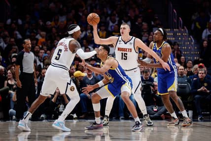 Feb 2, 2023; Denver, Colorado, USA; Denver Nuggets center Nikola Jokic (15) controls the ball against Golden State Warriors forward Kevon Looney (5) as guard Kentavious Caldwell-Pope (5) and guard Jordan Poole (3) battle for position in the first quarter at Ball Arena. Mandatory Credit: Isaiah J. Downing-USA TODAY Sports