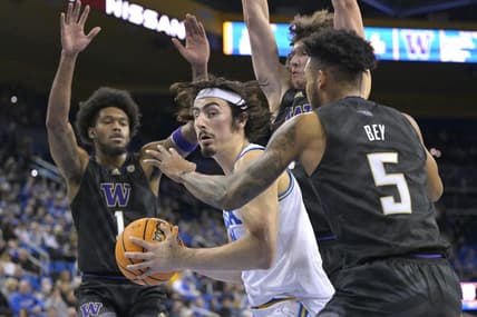 Feb 2, 2023; Los Angeles, California, USA; UCLA Bruins guard Jaime Jaquez Jr. (24) is defended under the basket by Washington Huskies guard Jamal Bey (5) and forward Keion Brooks (1) in the first half at Pauley Pavilion presented by Wescom. Mandatory Credit: Jayne Kamin-Oncea-USA TODAY Sports