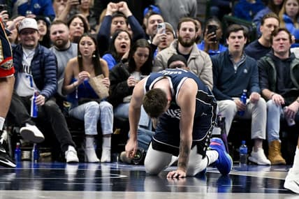 Feb 2, 2023; Dallas, Texas, USA; Dallas Mavericks guard Luka Doncic (77) kneels on the floor after he is fouled by New Orleans Pelicans forward Brandon Ingram (not pictured) as he drives to the basket during the second half at the American Airlines Center. Mandatory Credit: Jerome Miron-USA TODAY Sports