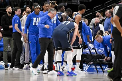 Feb 2, 2023; Dallas, Texas, USA; Dallas Mavericks guard Luka Doncic (77) is checked by a team trainer after he is fouled by New Orleans Pelicans forward Brandon Ingram (not pictured) as he drives to the basket during the second half at the American Airlines Center. Mandatory Credit: Jerome Miron-USA TODAY Sports
