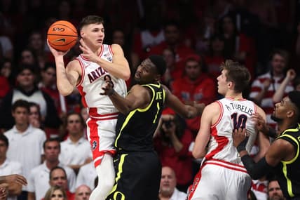 Feb 2, 2023; Tucson, Arizona, USA; Arizona Wildcats guard Pelle Larsson (3) makes a pass against Oregon Ducks center N'Faly Dante (1) to Arizona Wildcats forward Azuolas Tubelis (10) in the first hall at McKale Center. Mandatory Credit: Zachary BonDurant-USA TODAY Sports