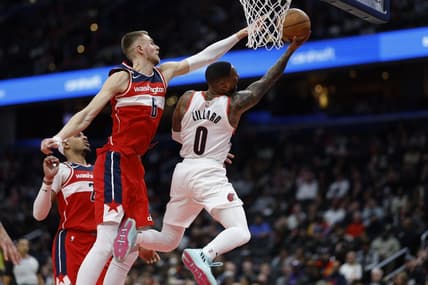 Feb 3, 2023; Washington, District of Columbia, USA; Portland Trail Blazers guard Damian Lillard (0) shoots the ball as Washington Wizards center Kristaps Porzingis (6) defends in the second quarter at Capital One Arena. Mandatory Credit: Geoff Burke-USA TODAY Sports
