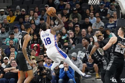 Feb 3, 2023; San Antonio, Texas, USA; Philadelphia 76ers guard Shake Milton (18) shoots over San Antonio Spurs forwards Stanley Johnson (34) and Zach Collins (23) during the first half at AT&T Center. Mandatory Credit: Scott Wachter-USA TODAY Sports