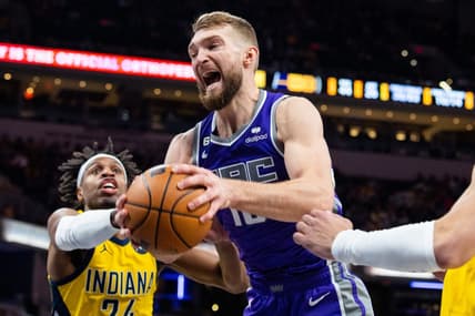 Feb 3, 2023; Indianapolis, Indiana, USA; Sacramento Kings forward Domantas Sabonis (10) rebounds the ball while  Indiana Pacers guard Buddy Hield (24) defends in the second half at Gainbridge Fieldhouse. Mandatory Credit: Trevor Ruszkowski-USA TODAY Sports