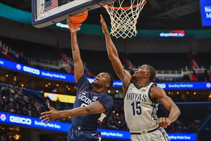 Feb 4, 2023; Washington, District of Columbia, USA; Connecticut Huskies guard Hassan Diarra (5) shoots as Georgetown Hoyas forward Bryson Mozone (15) defends during the first half at Capital One Arena. Mandatory Credit: Brad Mills-USA TODAY Sports