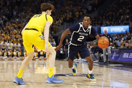 Feb 4, 2023; Milwaukee, Wisconsin, USA;  Butler Bulldogs guard Eric Hunter Jr. (2) drives towards the basket against Marquette Golden Eagles forward Ben Gold (21) during the first half at Fiserv Forum. Mandatory Credit: Jeff Hanisch-USA TODAY Sports