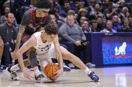 Feb 4, 2023; Cincinnati, Ohio, USA; Xavier Musketeers guard Kam Craft (12) battles for the ball against St. John's Red Storm guard Andre Curbelo (3) in the first half at Cintas Center. Mandatory Credit: Katie Stratman-USA TODAY Sports