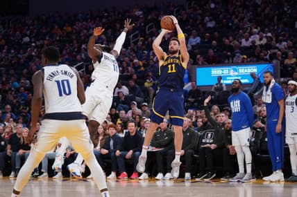 Feb 4, 2023; San Francisco, California, USA; Golden State Warriors guard Klay Thompson (11) shoots the ball over Dallas Mavericks forward Tim Hardaway Jr. (11) in the fourth quarter at the Chase Center. Mandatory Credit: Cary Edmondson-USA TODAY Sports