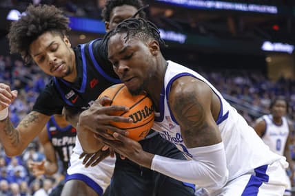 Feb 5, 2023; Newark, New Jersey, USA; Seton Hall Pirates forward KC Ndefo (13) secures a loose ball against DePaul Blue Demons guard Caleb Murphy (23) during the first half at Prudential Center. Mandatory Credit: Vincent Carchietta-USA TODAY Sports