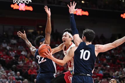 Feb 5, 2023; Lincoln, Nebraska, USA;  Nebraska Cornhuskers guard Keisei Tominaga (30) drives between Penn State Nittany Lions guard Jalen Pickett (22) and guard Andrew Funk (10) in the first half at Pinnacle Bank Arena. Mandatory Credit: Steven Branscombe-USA TODAY Sports
