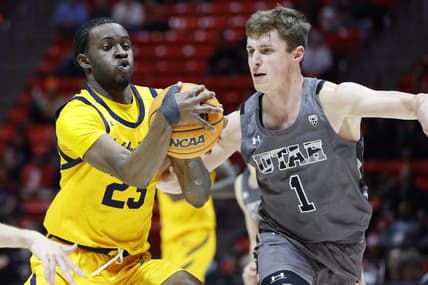 Feb 5, 2023; Salt Lake City, Utah, USA; California Golden Bears forward Obinna Anyanwu (23) drives against Utah Utes forward Ben Carlson (1) in the first half at Jon M. Huntsman Center. Mandatory Credit: Jeffrey Swinger-USA TODAY Sports