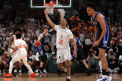 Feb 6, 2023; Coral Gables, Florida, USA; Miami Hurricanes guard Isaiah Wong (2) gestures after making a three point shot over Duke Blue Devils center Dereck Lively II (1) during the first half at Watsco Center. Mandatory Credit: Jasen Vinlove-USA TODAY Sports