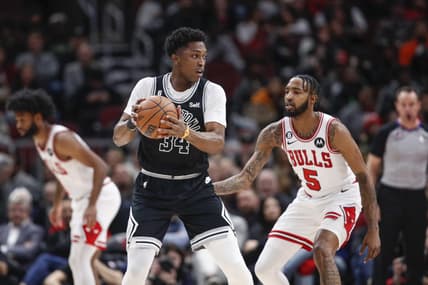 Feb 6, 2023; Chicago, Illinois, USA; San Antonio Spurs forward Stanley Johnson (34) looks to pass the ball against Chicago Bulls forward Derrick Jones Jr. (5) during the first half at United Center. Mandatory Credit: Kamil Krzaczynski-USA TODAY Sports