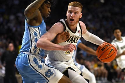 Feb 7, 2023; Winston-Salem, North Carolina, USA; Wake Forest Demon Deacons guard Cameron Hildreth (2) spins on North Carolina Tar Heels guard Caleb Love (2) during the first half at Lawrence Joel Veterans Memorial Coliseum. Mandatory Credit: William Howard-USA TODAY Sports