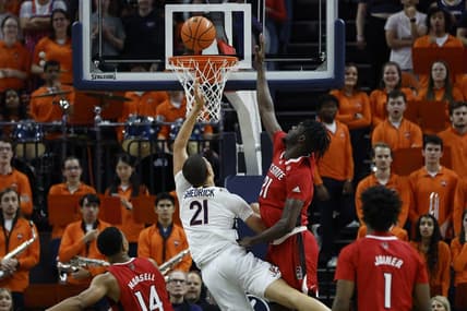 Feb 7, 2023; Charlottesville, Virginia, USA; Virginia Cavaliers forward Kadin Shedrick (21) is fouled while shooting by North Carolina State Wolfpack forward Ebenezer Dowuona (21) in the first half at John Paul Jones Arena. Mandatory Credit: Geoff Burke-USA TODAY Sports