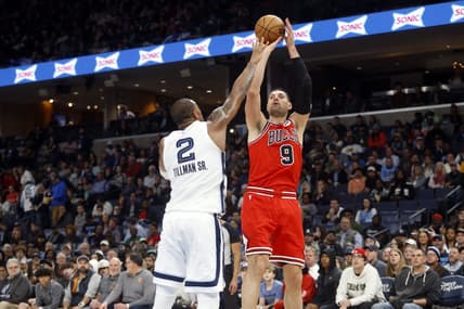 Feb 7, 2023; Memphis, Tennessee, USA; Chicago Bulls center Nikola Vucevic (9) shoots as Memphis Grizzlies forward Xavier Tillman (2) defends during the second half at FedExForum. Mandatory Credit: Petre Thomas-USA TODAY Sports