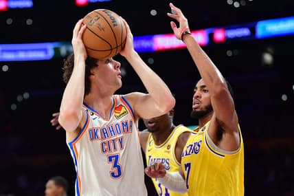 Feb 7, 2023; Los Angeles, California, USA; Oklahoma City Thunder guard Josh Giddey (3) shoots against Los Angeles Lakers forward Troy Brown Jr. (7) in the first half at Crypto.com Arena. Mandatory Credit: Gary A. Vasquez-USA TODAY Sports