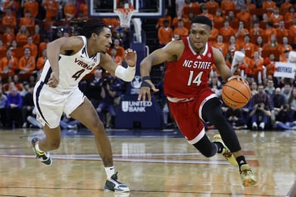 Feb 7, 2023; Charlottesville, Virginia, USA; North Carolina State Wolfpack guard Casey Morsell (14) drives to the basket as Virginia Cavaliers guard Armaan Franklin (4) defends in the first half at John Paul Jones Arena. Mandatory Credit: Geoff Burke-USA TODAY Sports
