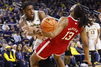 Feb 8, 2023; Ann Arbor, Michigan, USA;  Nebraska Cornhuskers forward Derrick Walker (13) is fouled by Michigan Wolverines forward Tarris Reed Jr. (32) in the first half at Crisler Center. Mandatory Credit: Rick Osentoski-USA TODAY Sports