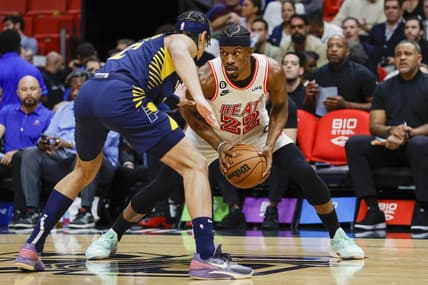Feb 8, 2023; Miami, Florida, USA; Miami Heat forward Jimmy Butler (22) protects the ball from Indiana Pacers guard Andrew Nembhard (2) during the first quarter at Miami-Dade Arena. Mandatory Credit: Sam Navarro-USA TODAY Sports