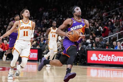 Feb 9, 2023; Atlanta, Georgia, USA; Phoenix Suns forward Josh Okogie (2) drives to the basket after a steal against Atlanta Hawks guard Trae Young (11) during the second half at State Farm Arena. Mandatory Credit: Dale Zanine-USA TODAY Sports