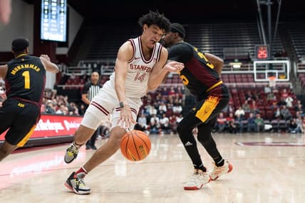 Feb 9, 2023; Stanford, California, USA;  Stanford Cardinal forward Spencer Jones (14) drives the ball around Arizona State Sun Devils guard Devan Cambridge (35) during the first half at Maples Pavilion. Mandatory Credit: Stan Szeto-USA TODAY Sports