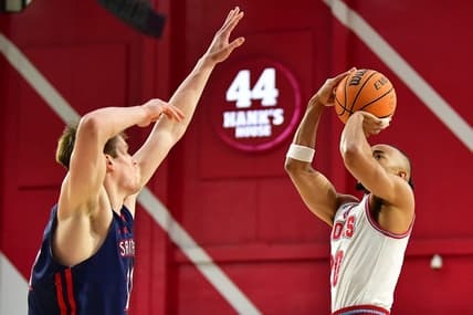 Feb 9, 2023; Los Angeles, California, USA; Loyola Marymount Lions guard Cam Shelton (20) shoots against St. Mary's Gaels center Mitchell Saxen (11) during the first half at Gersten Pavilion. Mandatory Credit: Gary A. Vasquez-USA TODAY Sports