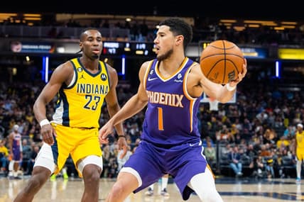 Feb 10, 2023; Indianapolis, Indiana, USA; Phoenix Suns guard Devin Booker (1) passes the ball while Indiana Pacers forward Aaron Nesmith (23) defends in the second quarter  at Gainbridge Fieldhouse. Mandatory Credit: Trevor Ruszkowski-USA TODAY Sports