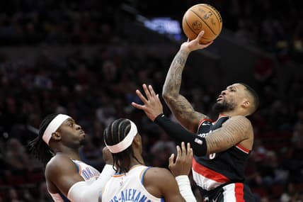 Feb 10, 2023; Portland, Oregon, USA; Portland Trail Blazers point guard Damian Lillard (0, right) is fouled while shooting by Oklahoma City Thunder point guard Shai Gilgeous-Alexander (2, left) during the first half at Moda Center. Mandatory Credit: Soobum Im-USA TODAY Sports