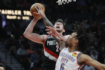 Feb 10, 2023; Portland, Oregon, USA; Portland Trail Blazers power forward Drew Eubanks (24) is fouled while shooting by Oklahoma City Thunder forward Jaylin Williams (6) during the first half at Moda Center. Mandatory Credit: Soobum Im-USA TODAY Sports
