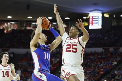 Feb 11, 2023; Norman, Oklahoma, USA; Kansas Jayhawks forward Jalen Wilson (10) drives against Oklahoma Sooners guard Grant Sherfield (25) during the first half at Lloyd Noble Center. Mandatory Credit: Alonzo Adams-USA TODAY Sports