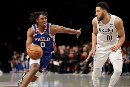 Feb 11, 2023; Brooklyn, New York, USA; Philadelphia 76ers guard Tyrese Maxey (0) drives to the basket against Brooklyn Nets guard Ben Simmons (10) during the second quarter at Barclays Center. Mandatory Credit: Brad Penner-USA TODAY Sports