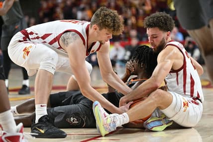 Feb 11, 2023; Ames, Iowa, USA; Iowa State Cyclones guard Gabe Kalscheur (right) and forward Aljaz Kunc (5) battle Oklahoma State Cowboys guard Caleb Asberry (5) for a loose ball during the first half at James H. Hilton Coliseum. Asberry  would be injured on the play. Mandatory Credit: Jeffrey Becker-USA TODAY Sports