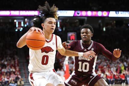 Feb 11, 2023; Fayetteville, Arkansas, USA; Arkansas Razorbacks guard Anthony Black (0) dribbles as Mississippi State Bulldogs guard Dashawn Davis (10) defends during the first half at Bud Walton Arena. Mandatory Credit: Nelson Chenault-USA TODAY Sports
