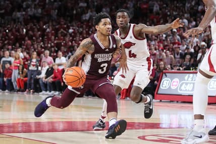Feb 11, 2023; Fayetteville, Arkansas, USA; Mississippi State Bulldogs guard Shakeel Moore (3) dribbles in the lane against Arkansas Razorbacks guard Davonte Davis (4) during the first half at Bud Walton Arena. The Bulldogs won 70-64. Mandatory Credit: Nelson Chenault-USA TODAY Sports