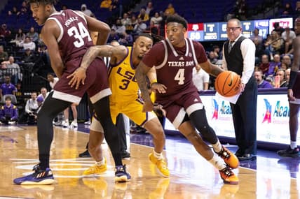 Feb 11, 2023; Baton Rouge, Louisiana, USA;  Texas A&M Aggies guard Wade Taylor IV (4) dribbles the ball against LSU Tigers guard Justice Hill (3) during the second half at Pete Maravich Assembly Center. Mandatory Credit: Stephen Lew-USA TODAY Sports