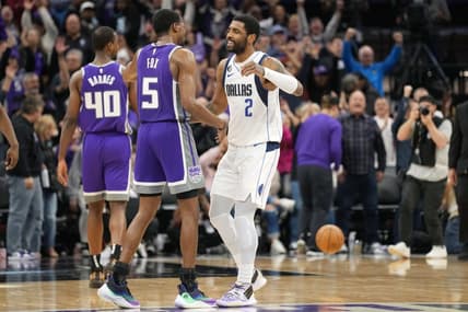 Feb 11, 2023; Sacramento, California, USA; Sacramento Kings guard De'Aaron Fox (5) and Dallas Mavericks guard Kyrie Irving (2) greet each other after the game at Golden 1 Center. Mandatory Credit: Darren Yamashita-USA TODAY Sports
