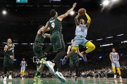 Feb 12, 2023; Boston, Massachusetts, USA; Memphis Grizzlies guard Ja Morant (12) shoots against Boston Celtics guard Derrick White (9) during the second quarter at TD Garden. Mandatory Credit: Winslow Townson-USA TODAY Sports