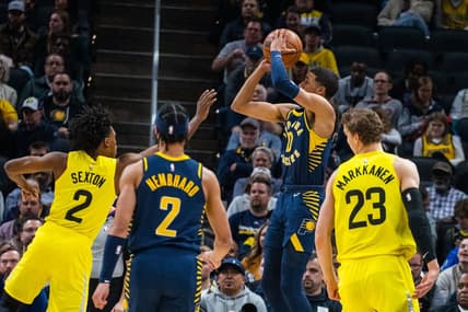 Feb 13, 2023; Indianapolis, Indiana, USA; Indiana Pacers guard Tyrese Haliburton (0) shoots the ball while Utah Jazz guard Collin Sexton (2) defends in the first quarter at Gainbridge Fieldhouse. Mandatory Credit: Trevor Ruszkowski-USA TODAY Sports
