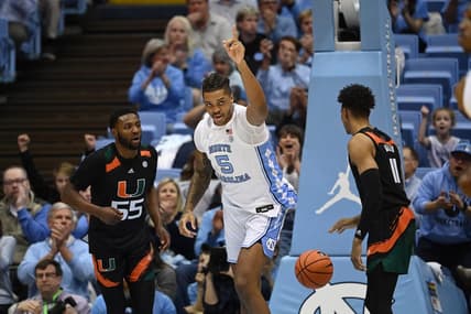 Feb 13, 2023; Chapel Hill, North Carolina, USA; North Carolina Tar Heels forward Armando Bacot (5) reacts as Miami (Fl) Hurricanes guard Wooga Poplar (55) and guard Jordan Miller (11) look on in the first half at Dean E. Smith Center. Mandatory Credit: Bob Donnan-USA TODAY Sports