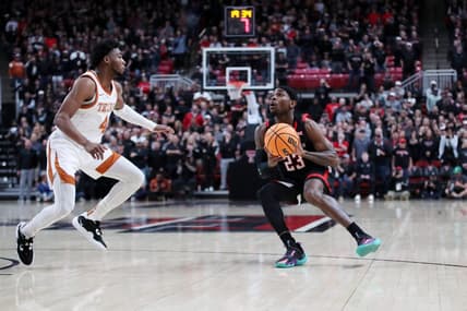 Feb 13, 2023; Lubbock, Texas, USA;  Texas Tech Red Raiders guard De'Vion Harmon (23) stops to shoot against Texas Longhorns guard Tyrese Hunter (4) in the first half at United Supermarkets Arena. Mandatory Credit: Michael C. Johnson-USA TODAY Sports